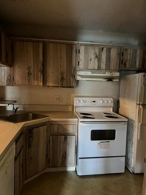 A kitchen features wood-grain cabinets, a white electric stove, a sink, and a refrigerator — 628 Sea Pine Way # H1, FL 33415, FL