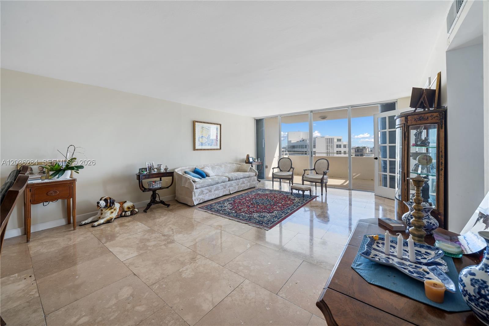 A living room features light tile floors, a patterned rug, and a balcony with city views — 11 Island Ave # 1708, Miami Beach FL 33139, MIAMI BEACH, FL
