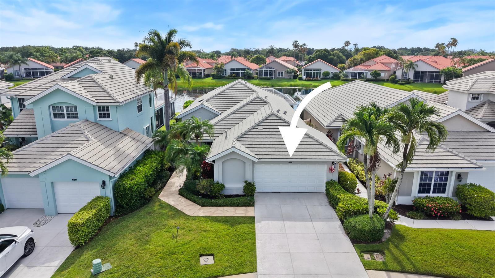 An aerial view shows a suburban house with a white garage and tiled roof — 637 Masters Way, Palm Beach Gardens FL 33418, PALM BEACH GARDENS, FL