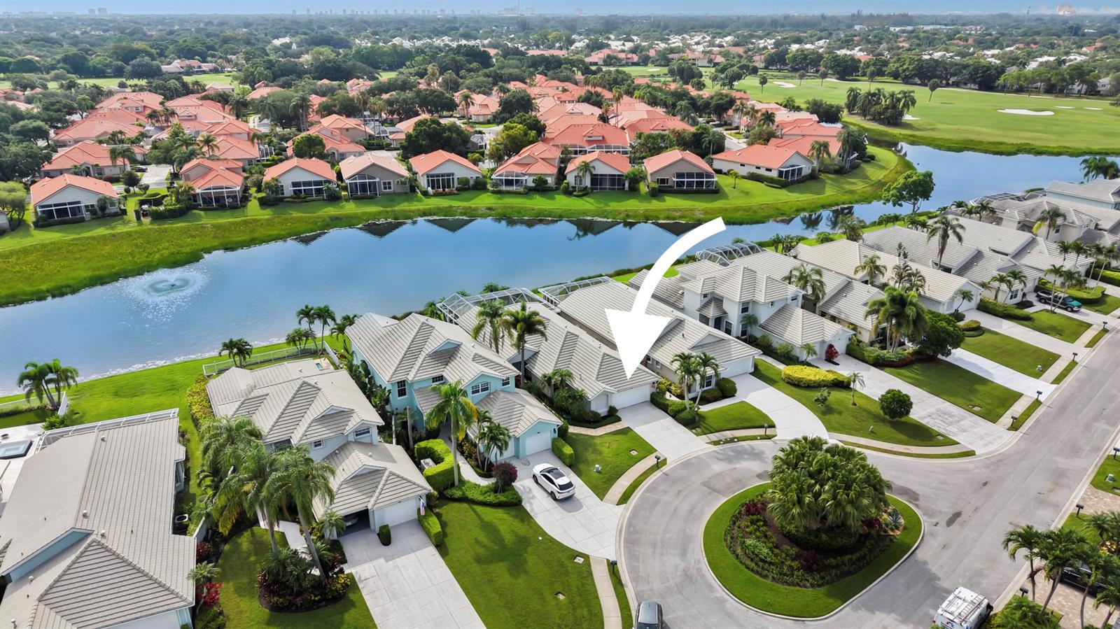 An aerial view shows a residential neighborhood with houses, a lake, and a golf course — 637 Masters Way, Palm Beach Gardens FL 33418, PALM BEACH GARDENS, FL