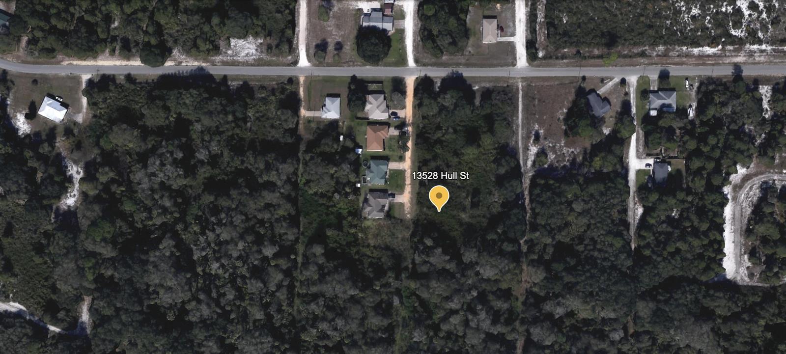 An aerial satellite view shows a residential lot surrounded by trees and nearby houses — 13528 Hull Street, FL 33875, FL