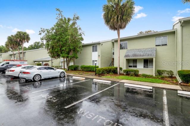 A two-story apartment building with a parking lot in the foreground — 631 SILVER PASS UNIT A, OCALA, FL