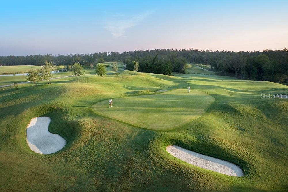 An aerial view of a golf course green with two golfers and sand bunkers — 19987 ENGLISH WALNUT PLACE, BROOKSVILLE, FL