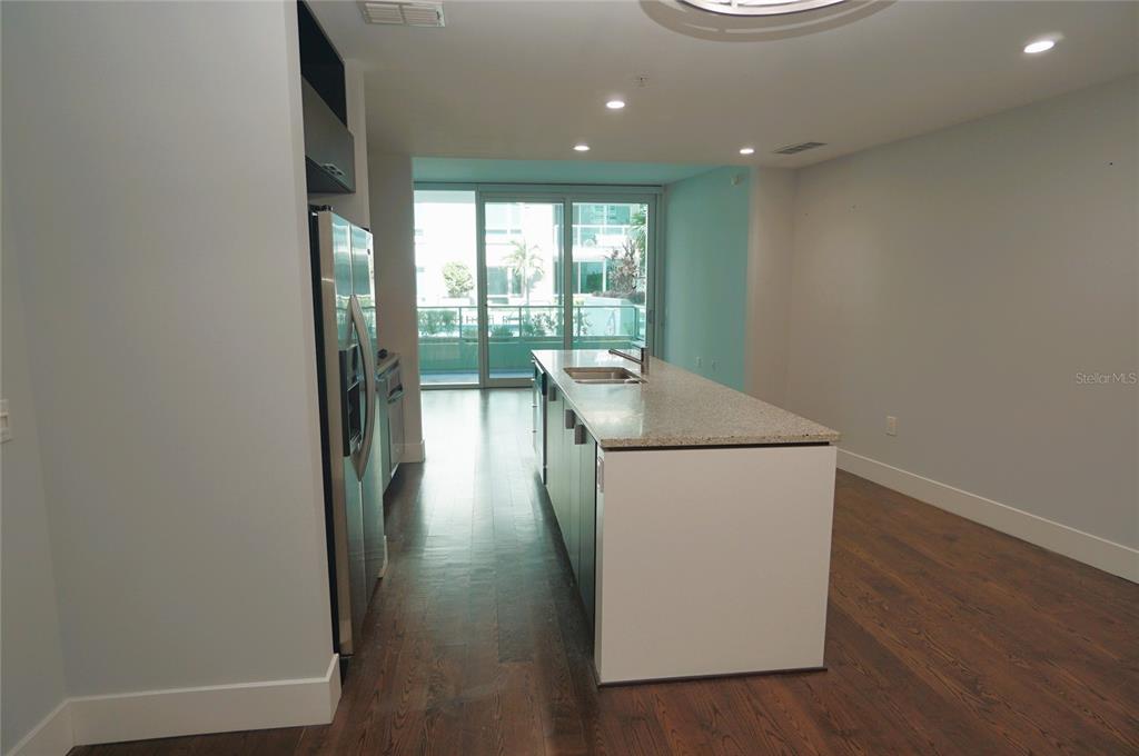 A kitchen with a central island, stainless steel appliances, and hardwood floors — 111 N 12TH STREET UNIT 1320, TAMPA, FL