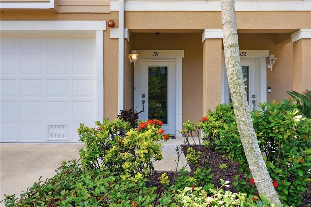 The exterior of a residential building features two adjacent front doors numbered 131 and 132 — 10425 PILOTHOUSE COURT UNIT 131, PLACIDA, FL