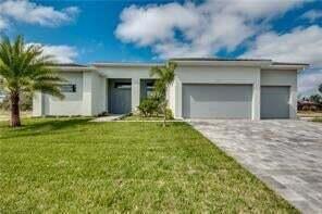 A single-story house with a white exterior, a paved driveway, and a palm tree — 618 N Federal Highway, FL 33460, FL