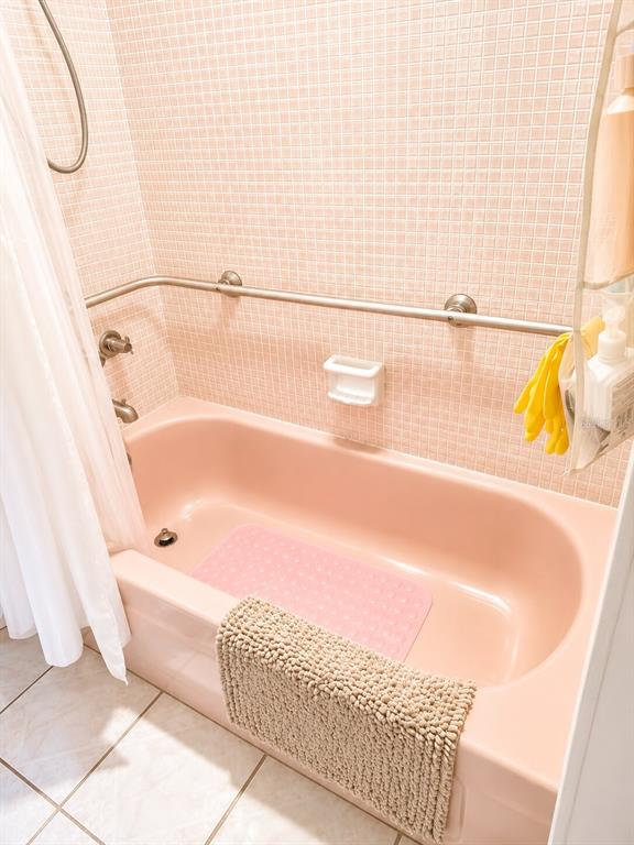 A pink bathtub with a grab bar and tiled walls in a bathroom — 2850 W GOLF BOULEVARD UNIT 212, POMPANO BEACH, FL