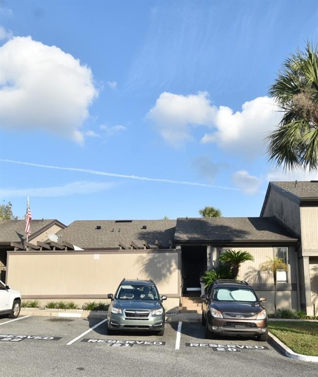 A single-story building with a tan facade and two parked cars in front — 686 LAKE VILLAS DRIVE UNIT 686, ALTAMONTE SPRINGS, FL