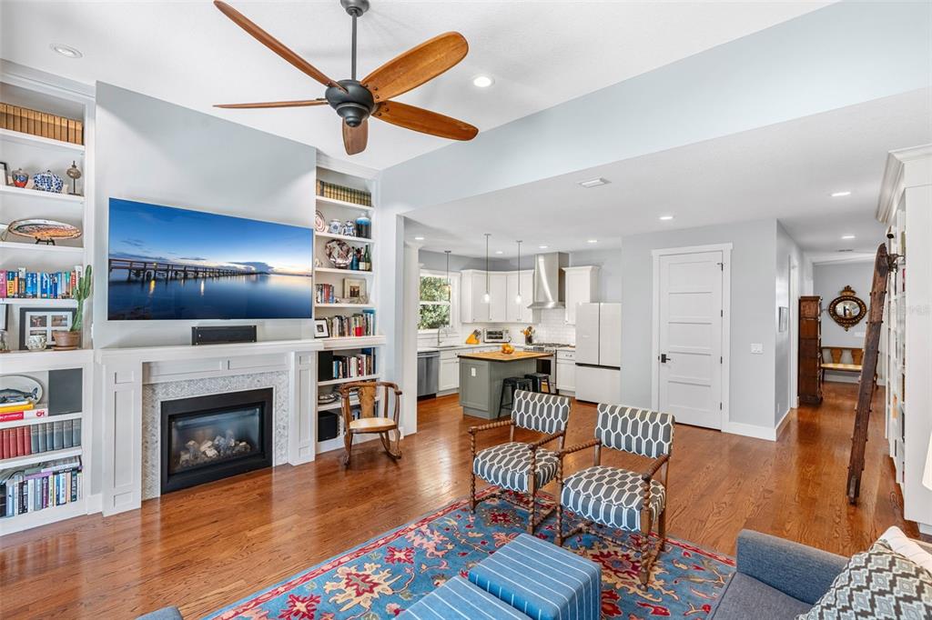 A foyer with hardwood floors, a staircase, French doors, and a built-in bookshelf — 2501 WINTER PARK ROAD, WINTER PARK, FL