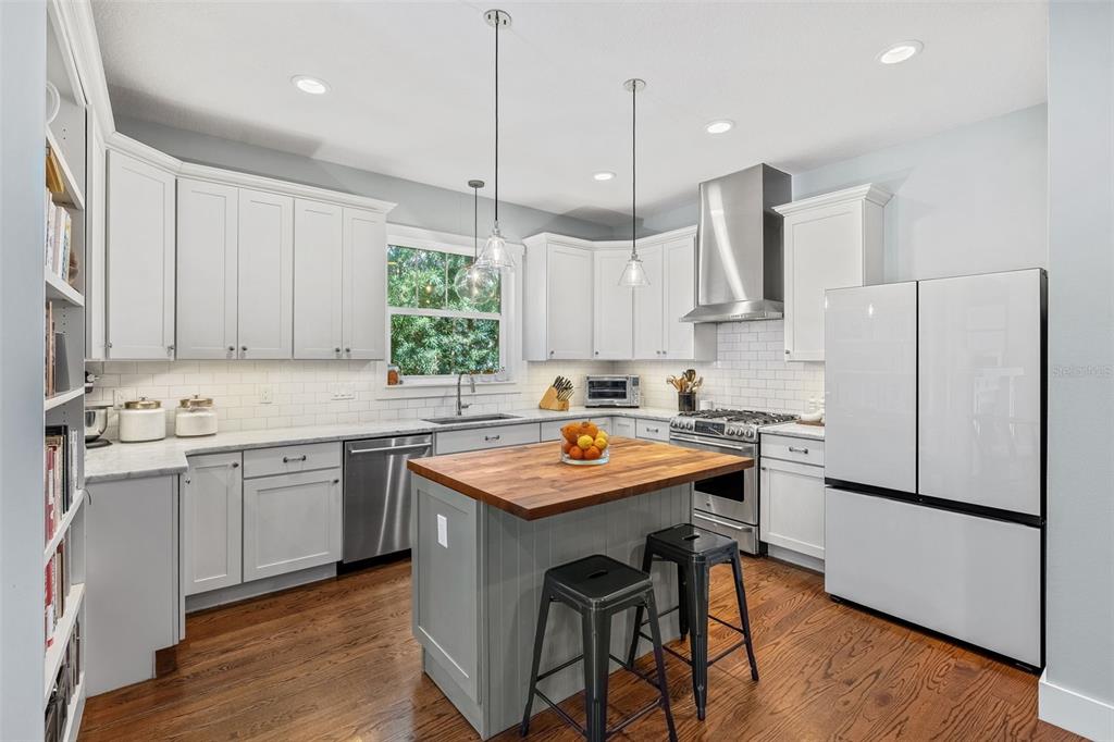 A home office with a desk and tree-patterned wallpaper is visible through open French doors — 2501 WINTER PARK ROAD, WINTER PARK, FL