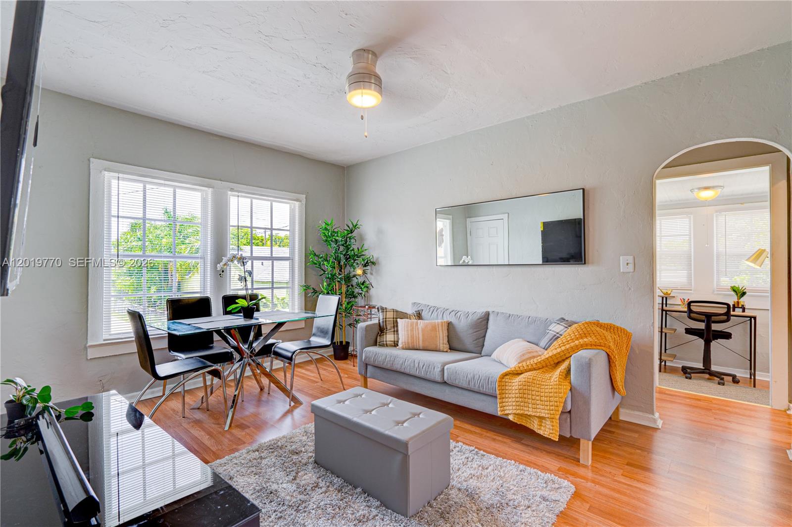 A living room features a grey sofa, a glass dining table, and hardwood flooring — 227 SW 30th Ave # B, Miami FL 33135, MIAMI, FL