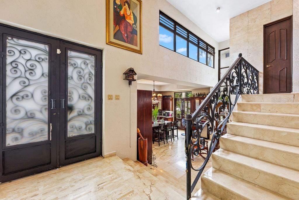 An entryway features a double door, a stone staircase with iron railing, and marble flooring — 1889 ORQUIDEA, SAN JUAN, PR