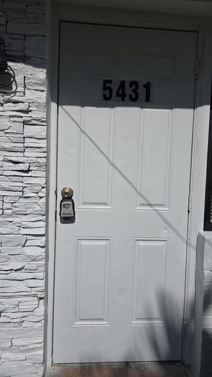 A white exterior door with the number 5431 and a lockbox mounted on the handle — 5431 NW 30th Avenue, Miami FL 33142, MIAMI, FL