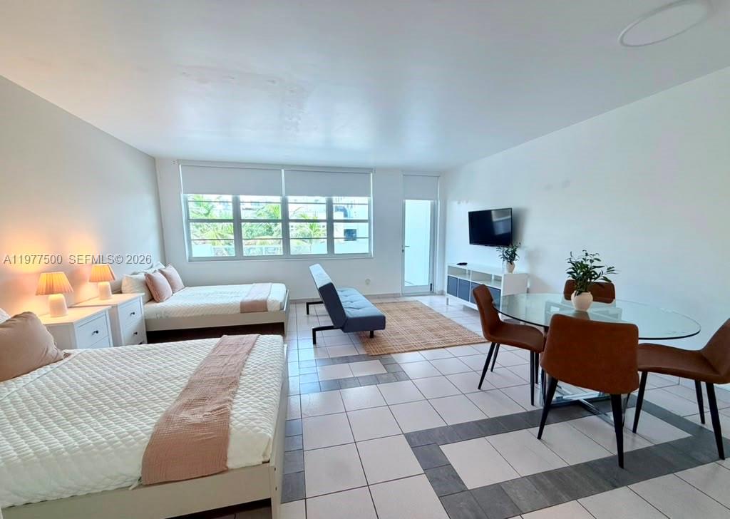 This room features two beds, a dining area, a sofa, and white tiled flooring — 100 Lincoln Rd # 304, Miami Beach FL 33139, MIAMI BEACH, FL