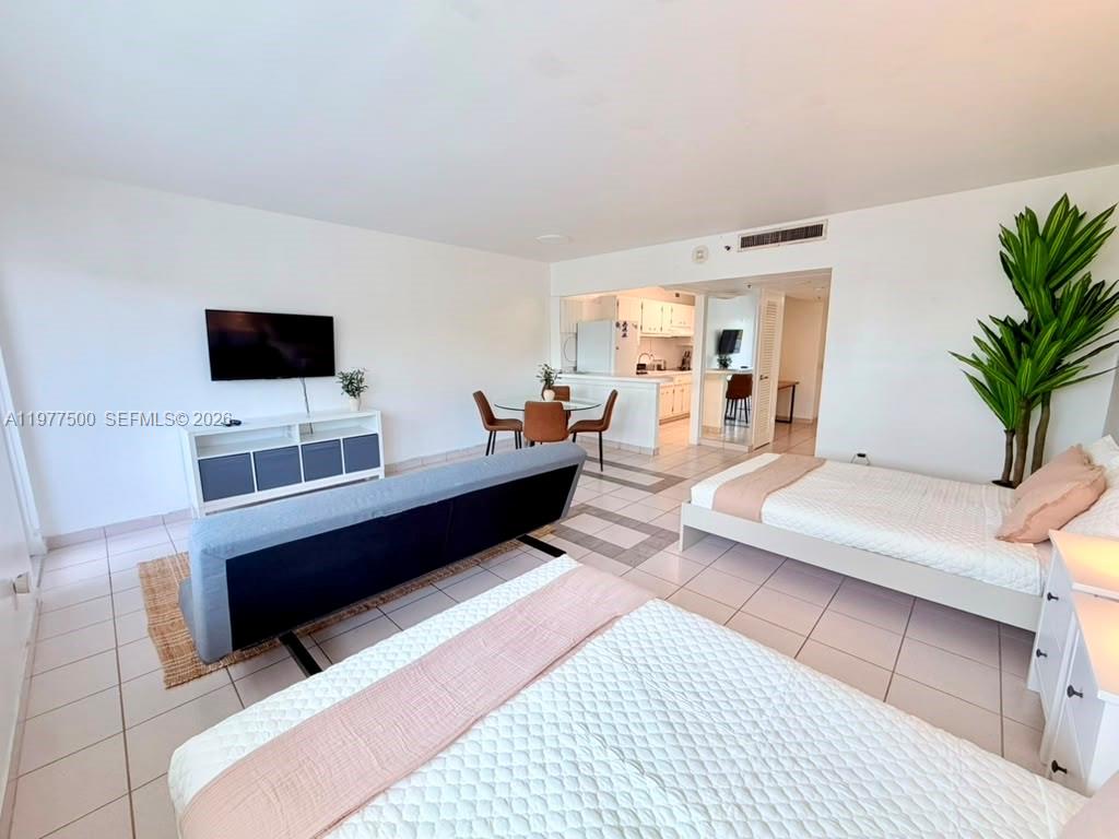 This studio apartment features a living area, dining space, kitchen, and two beds — 100 Lincoln Rd # 304, Miami Beach FL 33139, MIAMI BEACH, FL