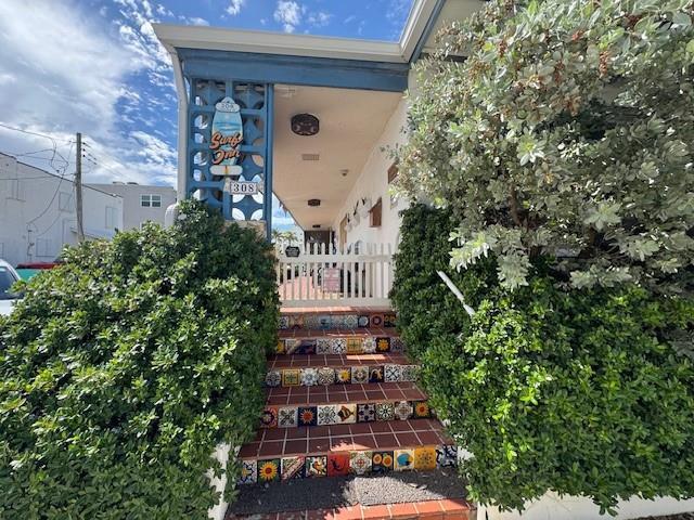 A set of stairs with decorative tiles leads to the entrance of a building — 308 Monroe Street, Hollywood FL 33019, HOLLYWOOD, FL