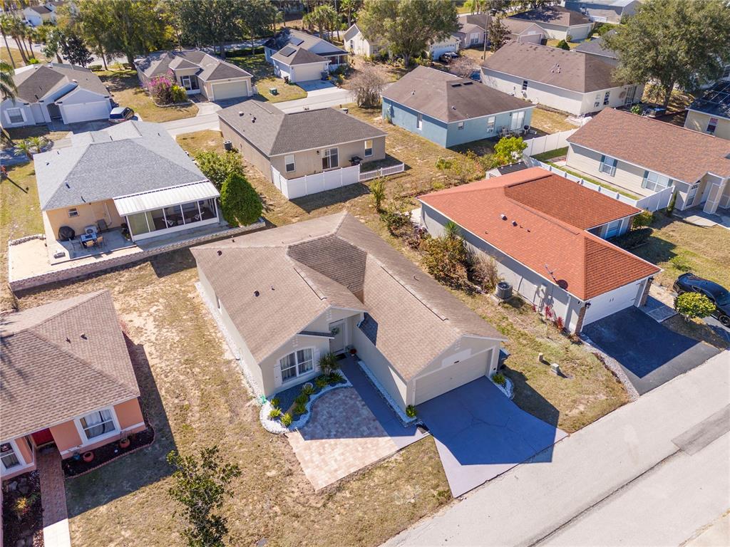 An aerial view shows a suburban neighborhood with several single-story houses and paved driveways — 50989 HIGHWAY 27 UNIT 274, DAVENPORT, FL