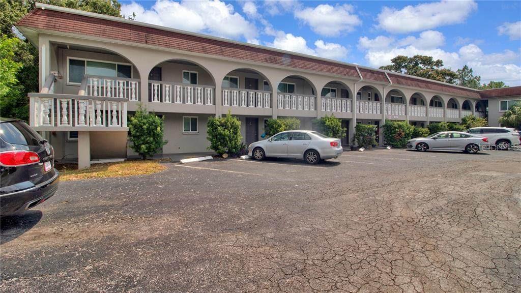 A two-story apartment building with arched walkways and a parking lot in front — 5900 22ND AVENUE N UNIT 8, ST PETERSBURG, FL