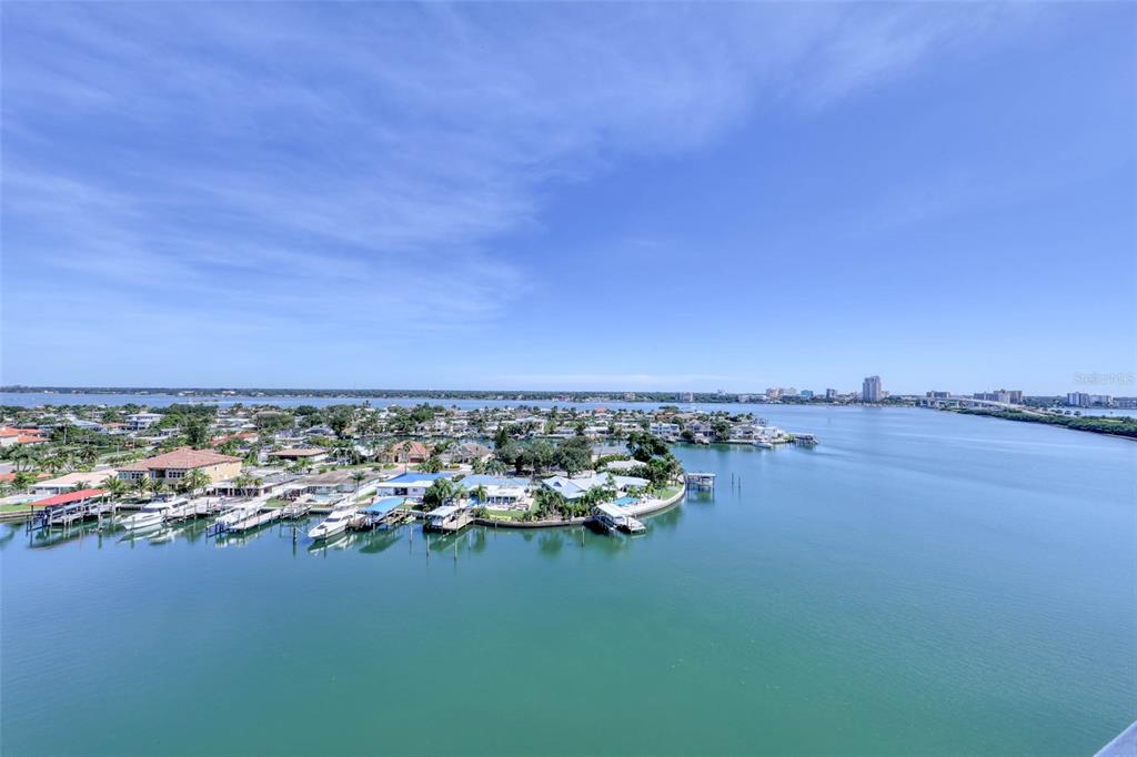 An aerial view of a waterfront residential area with docks and boats on a bay — 31 ISLAND WAY UNIT 1404, CLEARWATER, FL