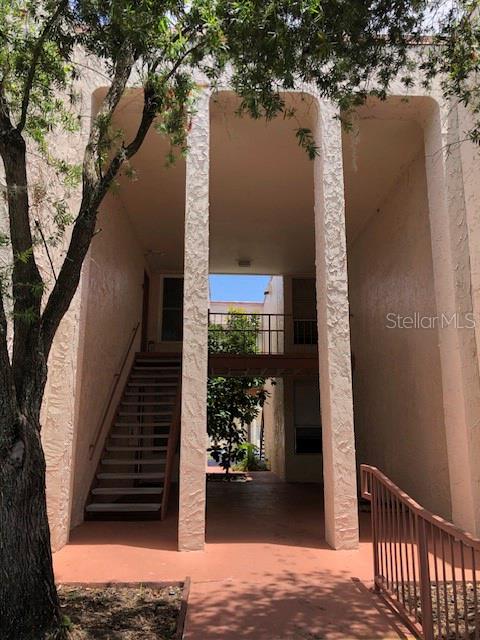 An exterior view of a multi-story apartment building with an open breezeway and metal stairs — 548 ORANGE UNIT 14, ALTAMONTE SPRINGS, FL