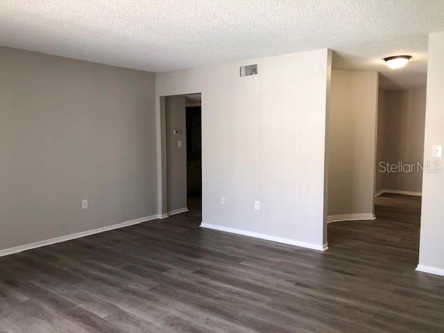 An empty room with light gray walls and dark wood-look flooring — 548 ORANGE UNIT 14, ALTAMONTE SPRINGS, FL