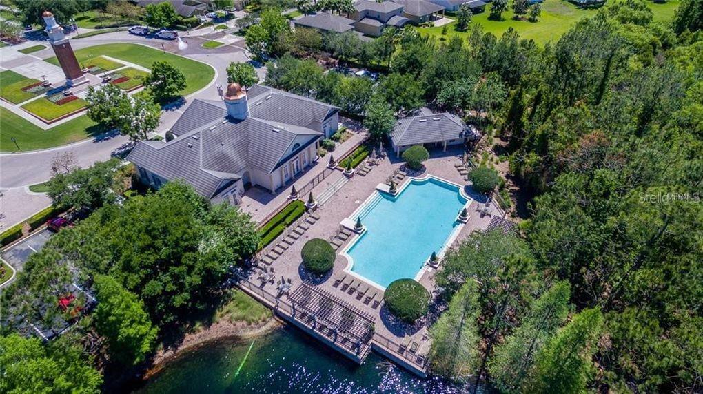 An aerial view shows a community clubhouse with a swimming pool and a nearby tower — 15171 BRIDGEWATER CROSSINGS BOULEVARD, WINTER GARDEN, FL