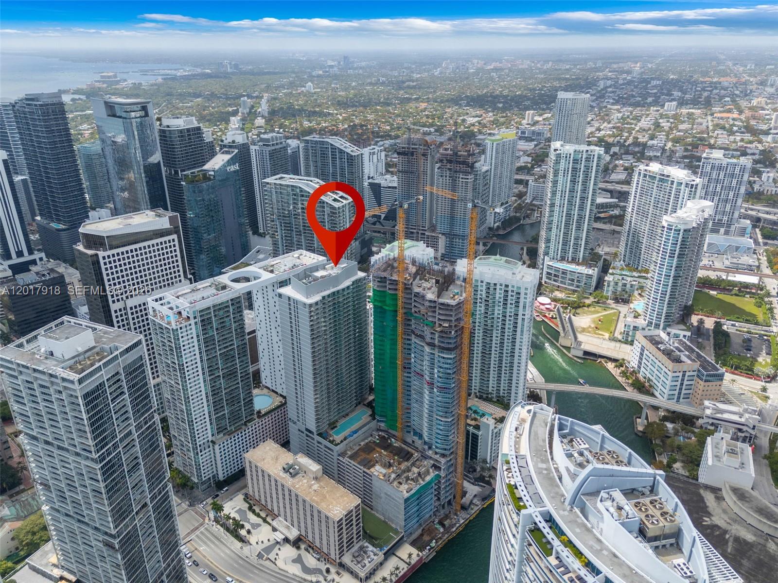 An aerial view of a dense urban skyline featuring numerous high-rise buildings and construction sites — 77 SE 5 # 1601, Miami FL 33131, MIAMI, FL