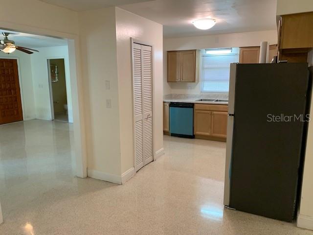 A kitchen features light wood cabinets, a blue dishwasher, and a large refrigerator — 6367 KEARCE STREET, ORLANDO, FL