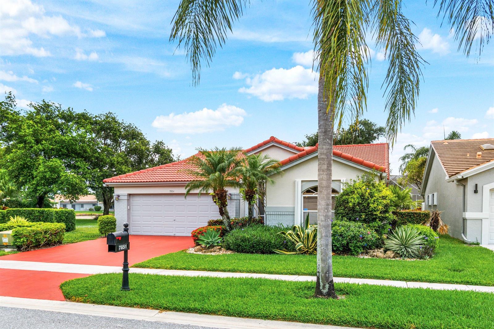 A single-story house with a red tile roof, a two-car garage, and a palm tree — 7851 Sailing Shores Terrace, Boynton Beach FL 33437, BOYNTON BEACH, FL
