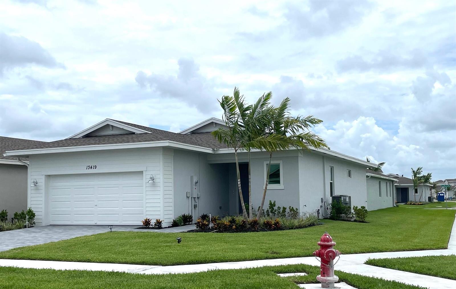 A single-story house with a white garage, gray roof, and a red fire hydrant nearby — 13419 Noble Drive, Delray Beach FL 33484, DELRAY BEACH, FL