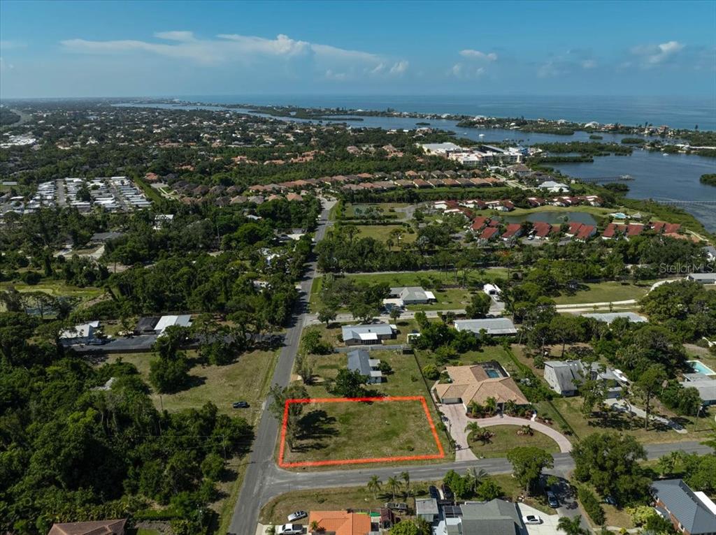 An aerial view shows a vacant rectangular lot outlined in red within a residential neighborhood — SARABAY ROAD, OSPREY, FL