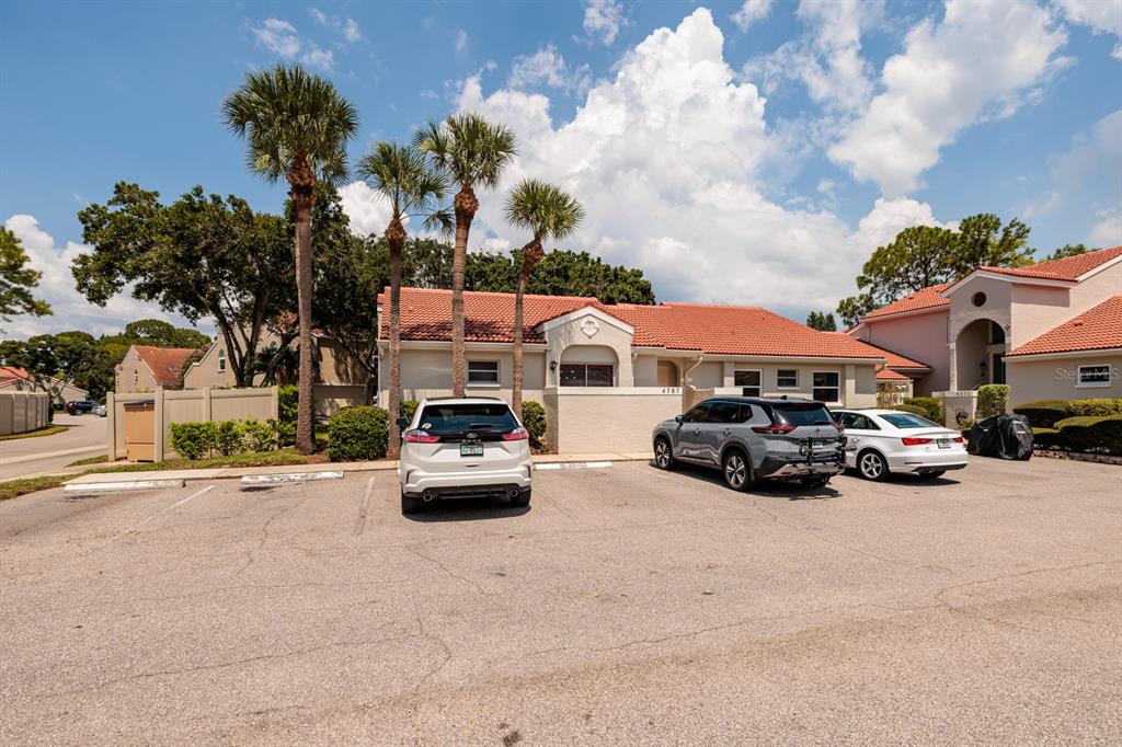 A single-story building with a tiled roof and three cars parked in front — 4787 PALERMO COURT NE UNIT 4787, ST PETERSBURG, FL