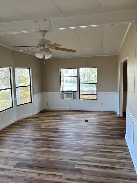 A covered concrete patio features a white exterior wall, stairs, and a lattice privacy fence — 9863 SCEPTER AVENUE, BROOKSVILLE, FL