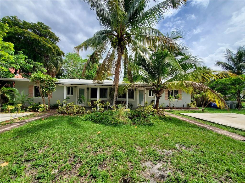 A single-story house with a white exterior, a palm tree in the front yard, and a lawn — 3204 NE 6th Street, Pompano Beach FL 33062, POMPANO BEACH, FL