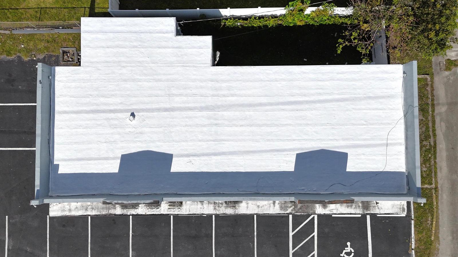 An aerial view shows a flat, white-coated commercial roof with two prominent shadows — 3000 N 22nd Avenue, Hollywood FL 33020, HOLLYWOOD, FL