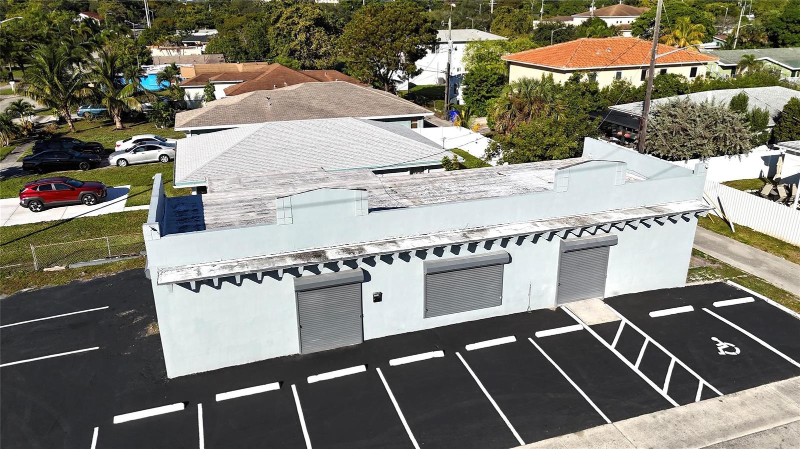 An aerial view of a single-story commercial building with a flat roof and parking lot — 3000 N 22nd Avenue, Hollywood FL 33020, HOLLYWOOD, FL
