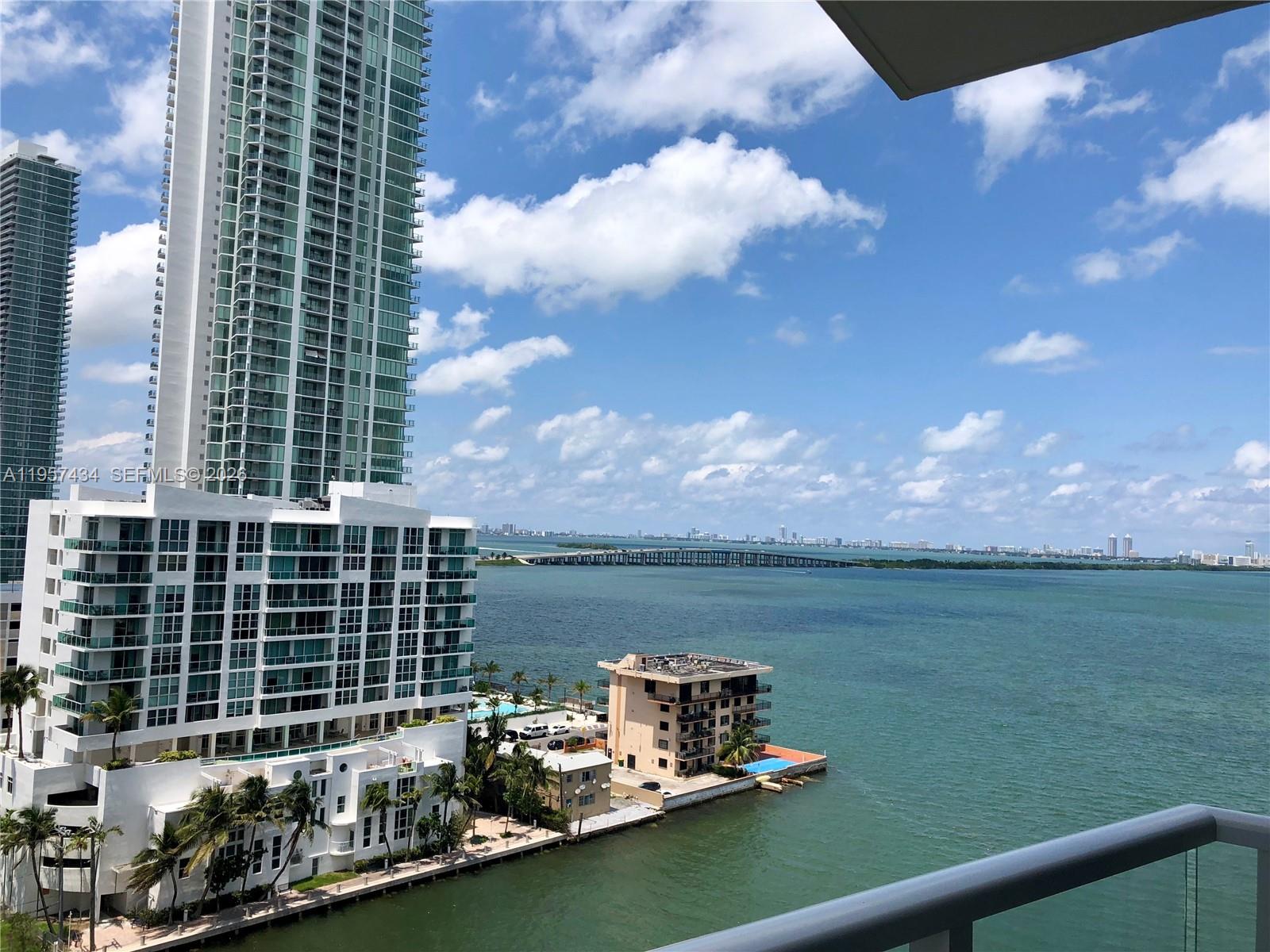 An elevated view of a coastal city skyline, a bridge, and high-rise buildings over water — 601 NE 27TH ST # 801, Miami FL 33137, MIAMI, FL