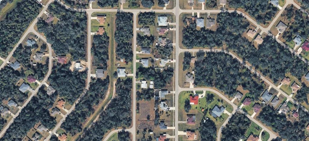 This is an aerial view of a residential neighborhood with houses surrounded by dense trees — 0 ATWATER DRIVE, NORTH PORT, FL
