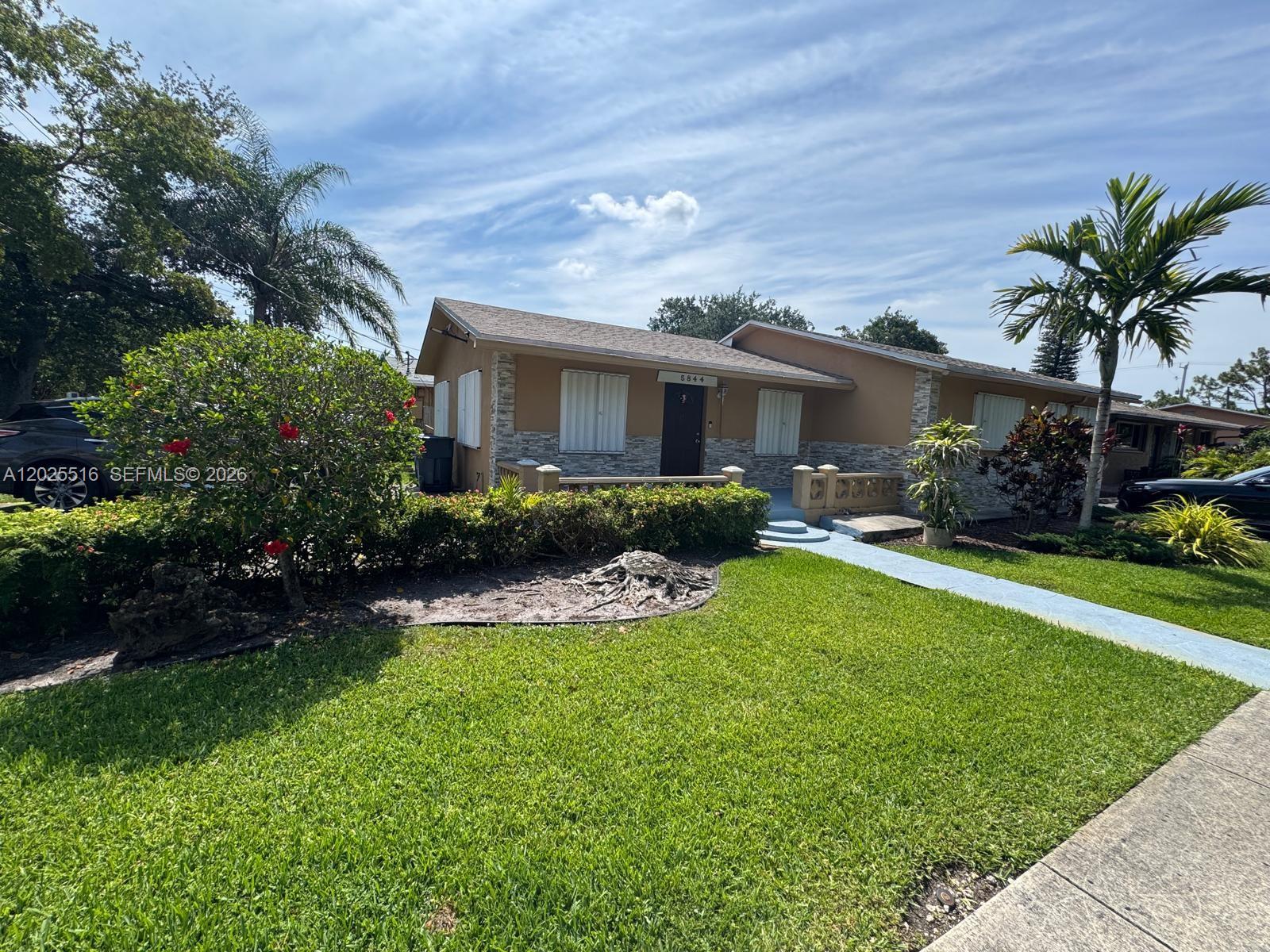 A single-story house with a tan exterior, stone accents, and a front lawn — 5844-5846 Pierce St, Hollywood FL 33021, HOLLYWOOD, FL
