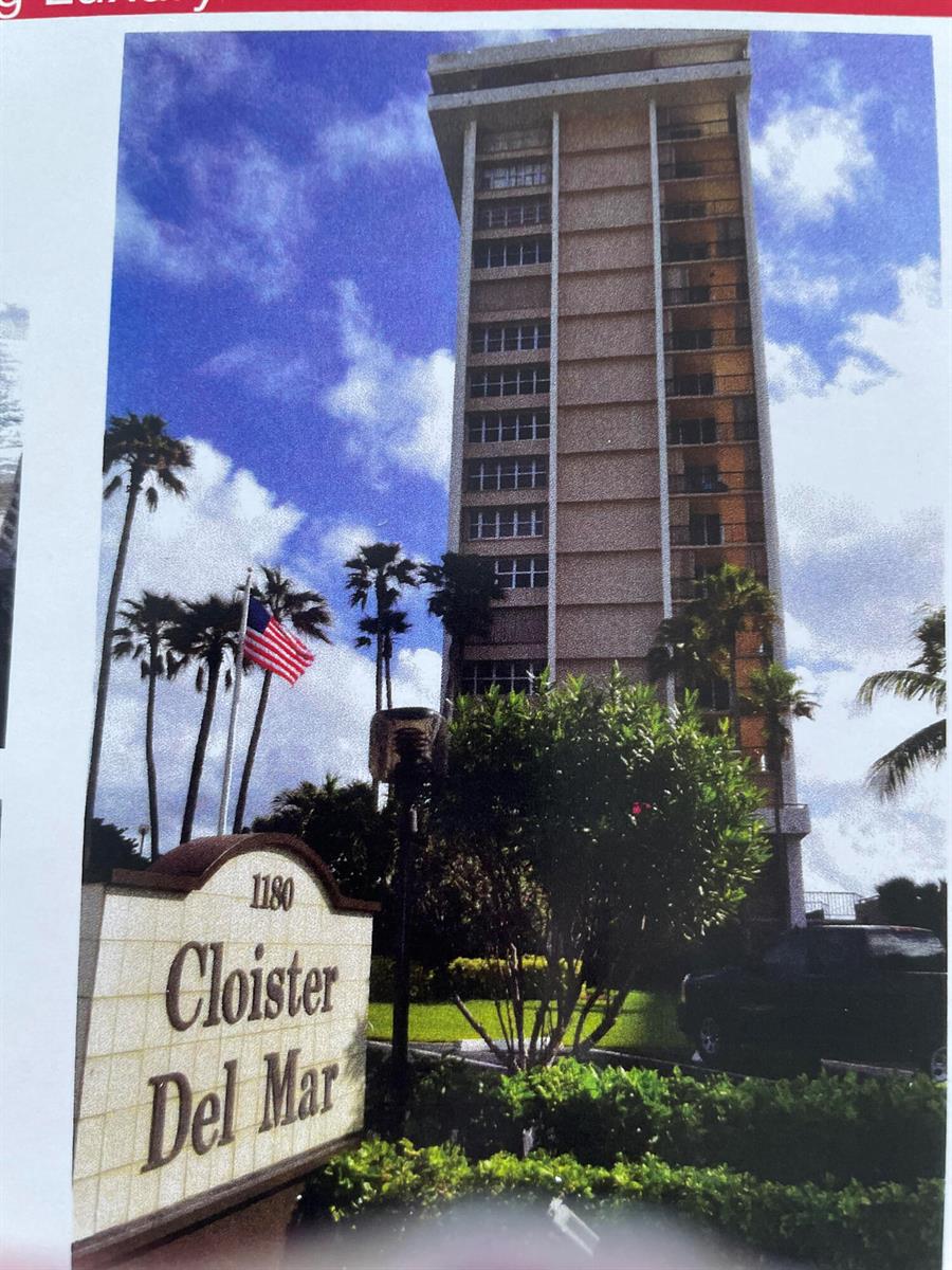 A tall residential building stands behind a sign for Cloister Del Mar with palm trees — 1180 S Ocean Boulevard # 5c, Boca Raton FL 33432, BOCA RATON, FL