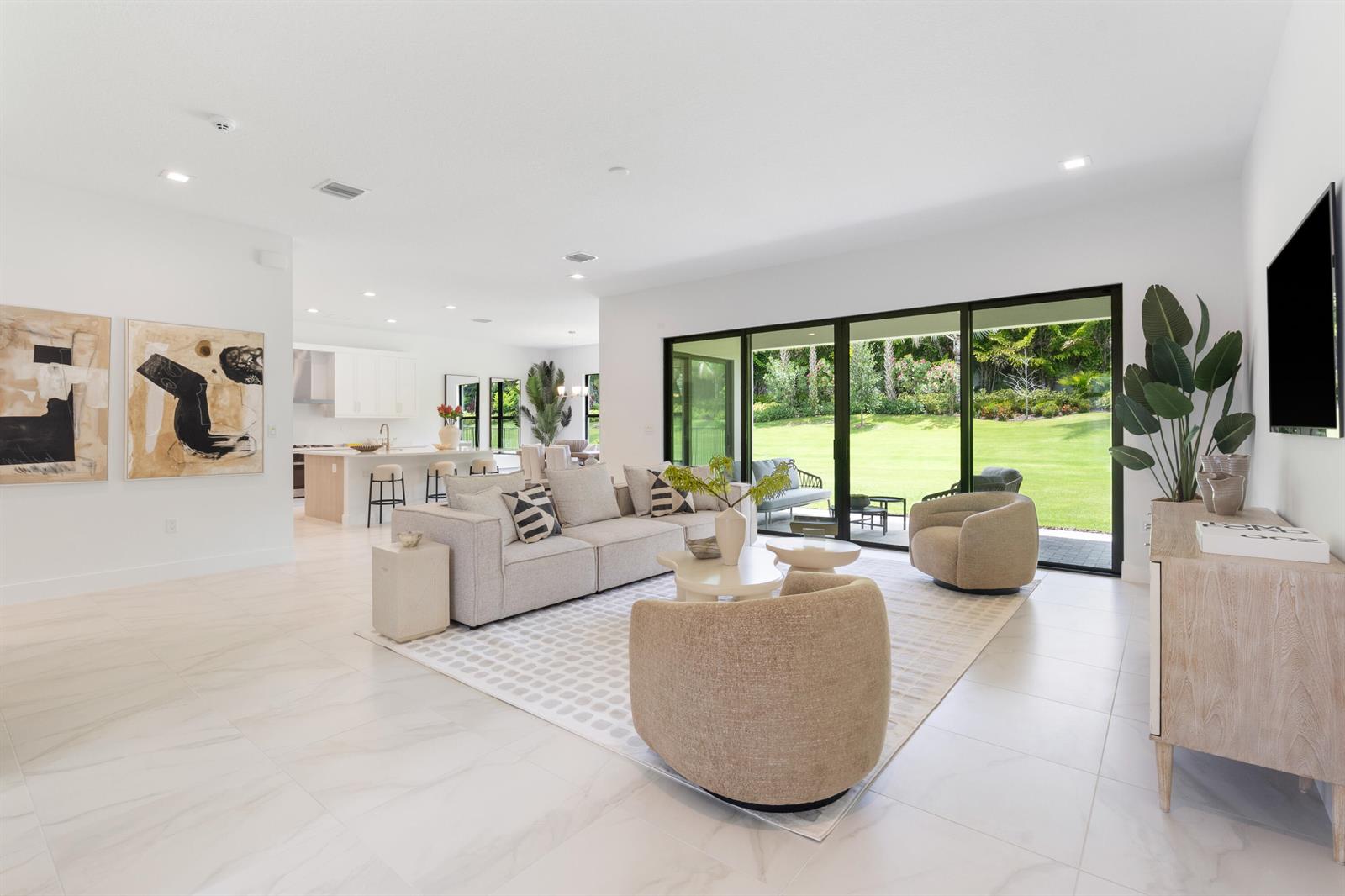 A bright living room features a beige sofa, two armchairs, and large sliding glass doors — 21054 Violet Fields Way, Boca Raton FL 33434, BOCA RATON, FL