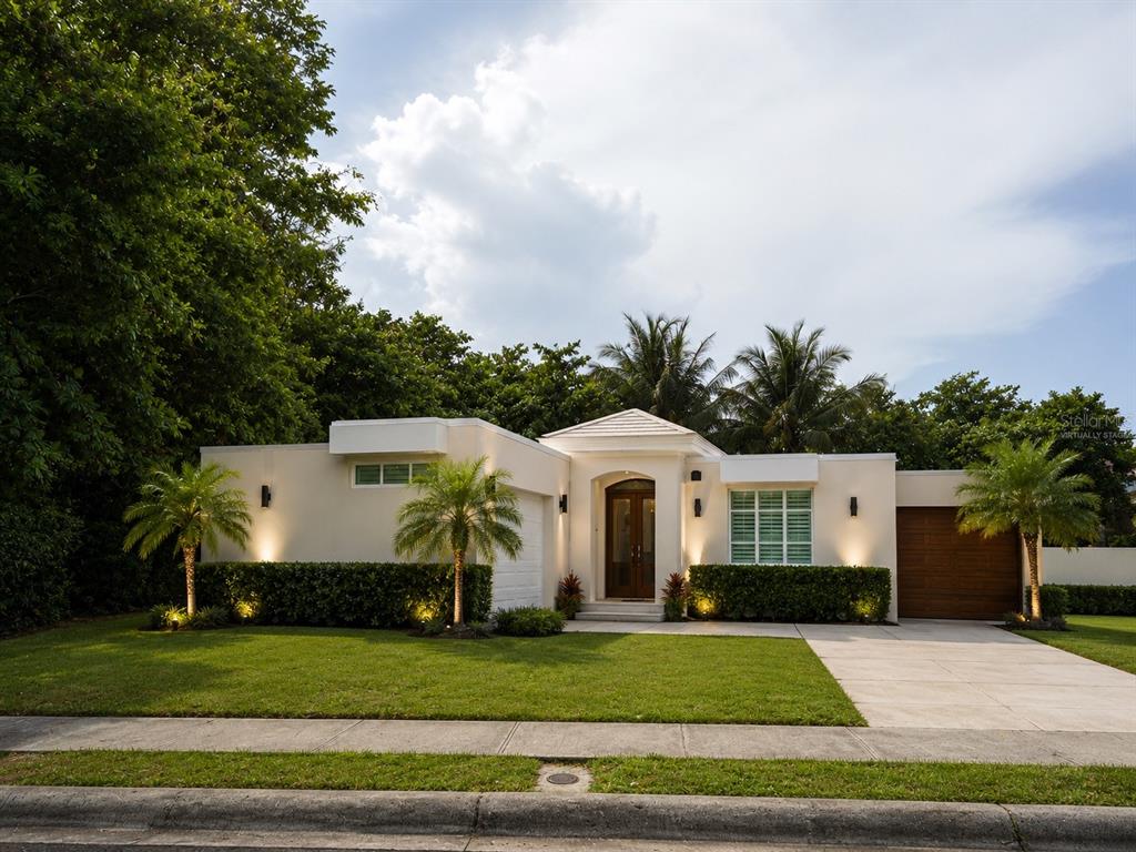 A single-story house with a flat roof, stucco exterior, palm trees, and a concrete driveway — OCEAN FOREST Lot 2, RIO GRANDE, PR