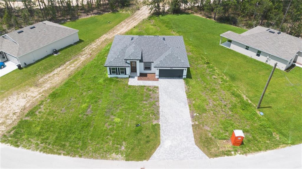 An aerial view shows a single-story house with a gray roof and a paved driveway — 13265 SW 85TH CIRCLE, OCALA, FL