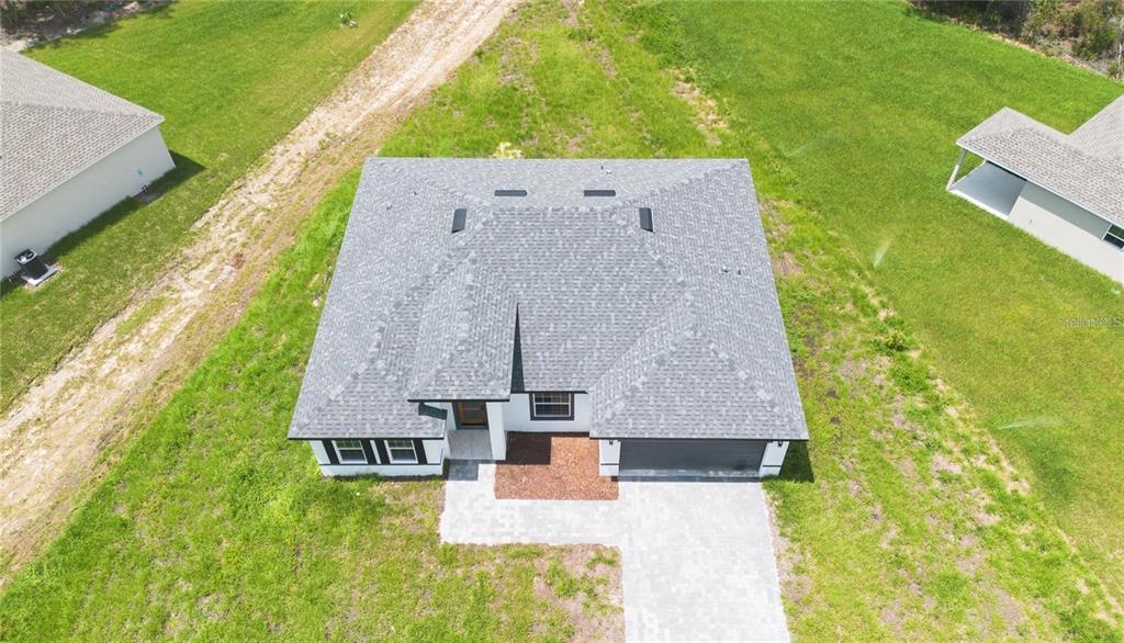 An aerial view shows a single-story house with a gray shingled roof and driveway — 13265 SW 85TH CIRCLE, OCALA, FL