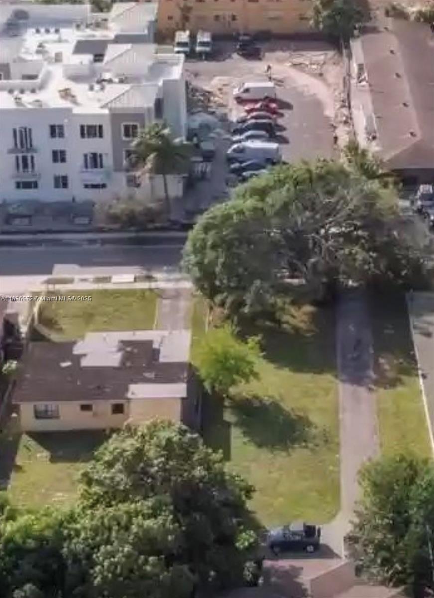 An aerial view shows a residential area with a parking lot, trees, and nearby buildings — 2229 Adams St, Hollywood FL 33020, HOLLYWOOD, FL