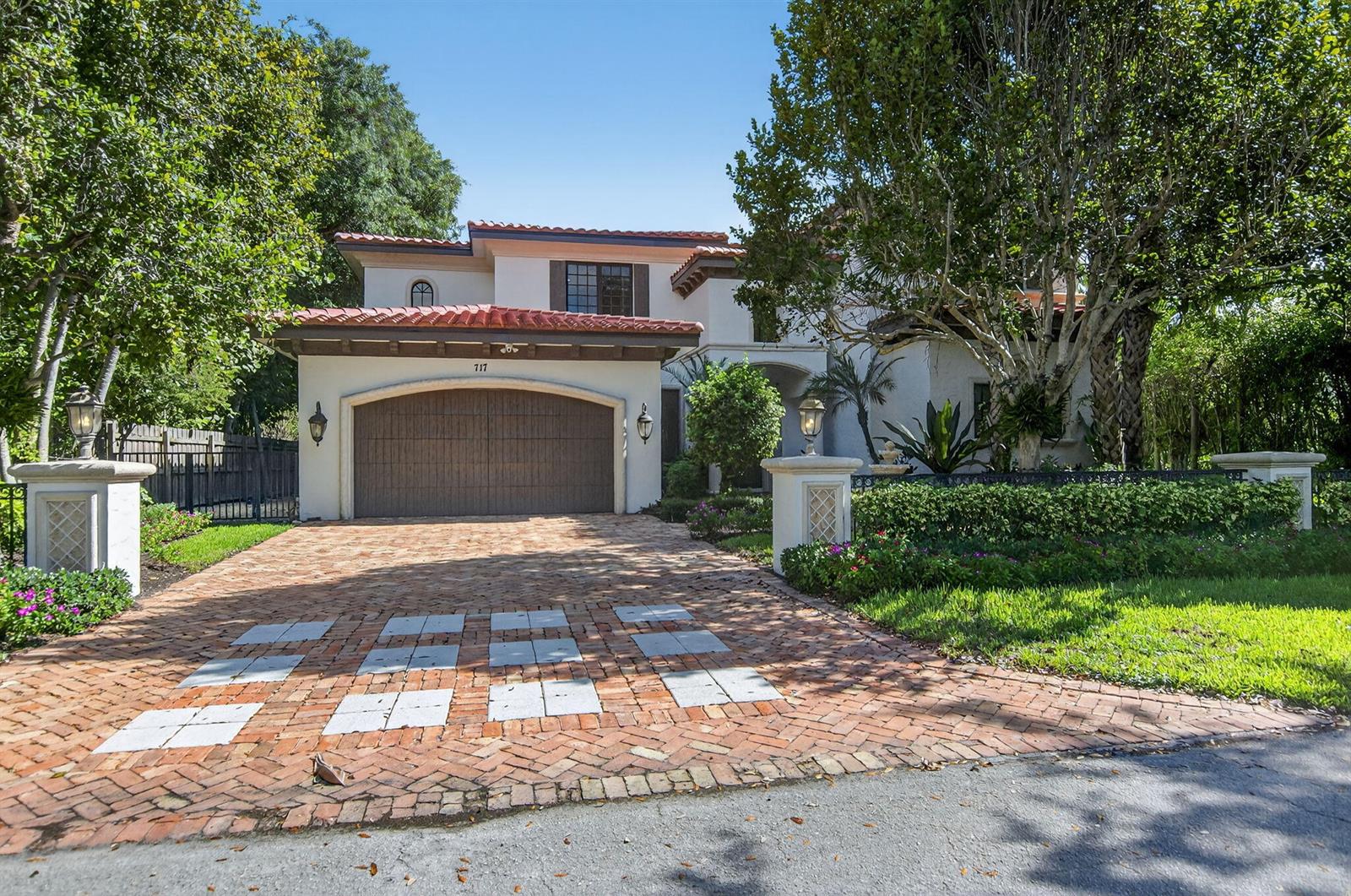 A two-story house with a red tile roof, a brick driveway, and a garage — 717 NW 4th Street, Boca Raton FL 33486, BOCA RATON, FL