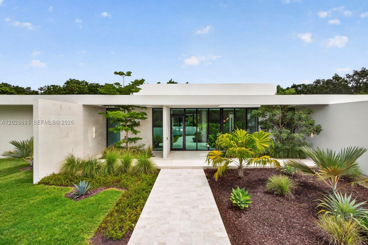 A modern, flat-roofed house features a stone walkway leading to a glass-paneled front entrance — 5671 SW 130th Ave, Southwest Ranches FL 33330, SOUTHWEST RANCHES, FL