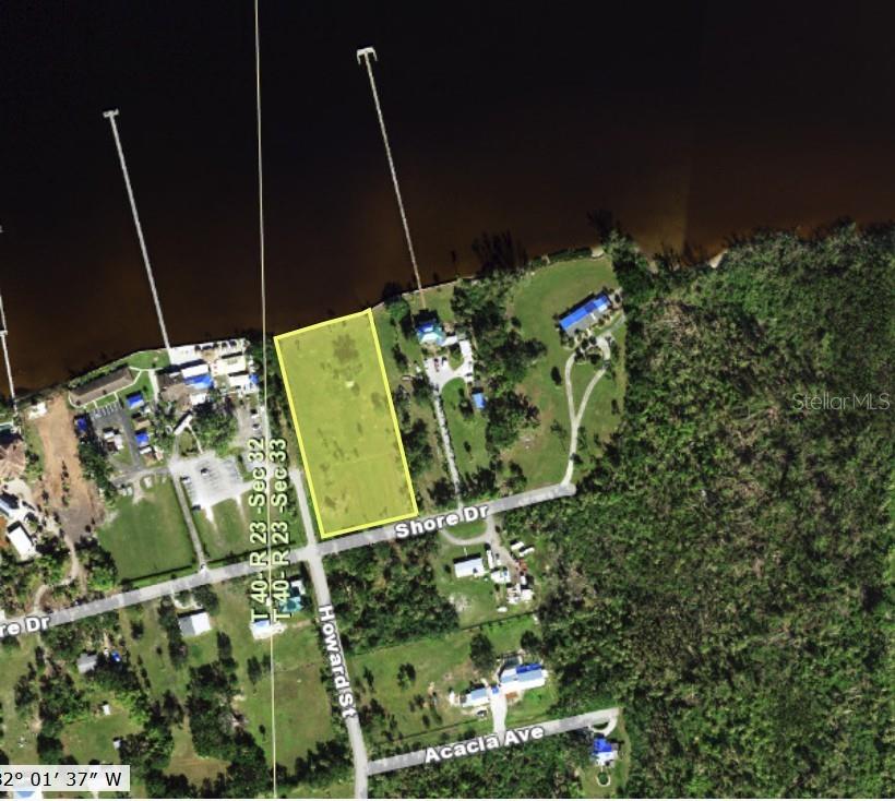 An aerial map view shows a rectangular vacant lot situated along a waterfront road — 26014 SHORE DRIVE, PUNTA GORDA, FL
