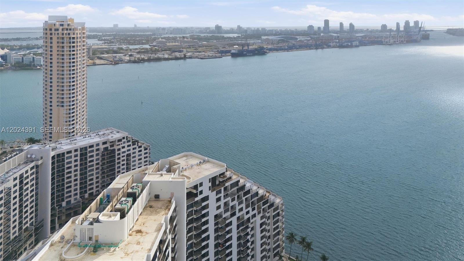An aerial view shows high-rise apartment buildings overlooking a large body of water and port — 520 Brickell Key Dr # A1615, Miami FL 33131, MIAMI, FL