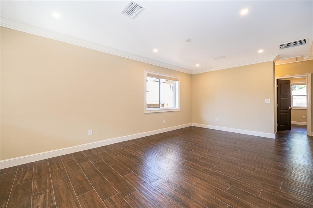 A room with wood-look tile flooring, a dark wood kitchen island, and a laundry area — 623 FLORIDA STREET, ORLANDO, FL